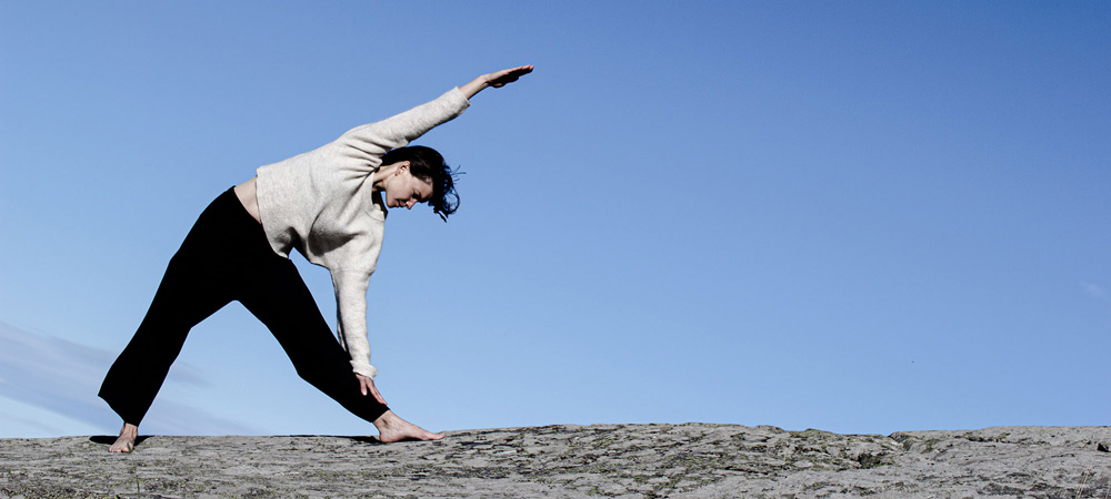 Trikonasana, Lotta joogaa kailliolla, taustalla sininen taivat